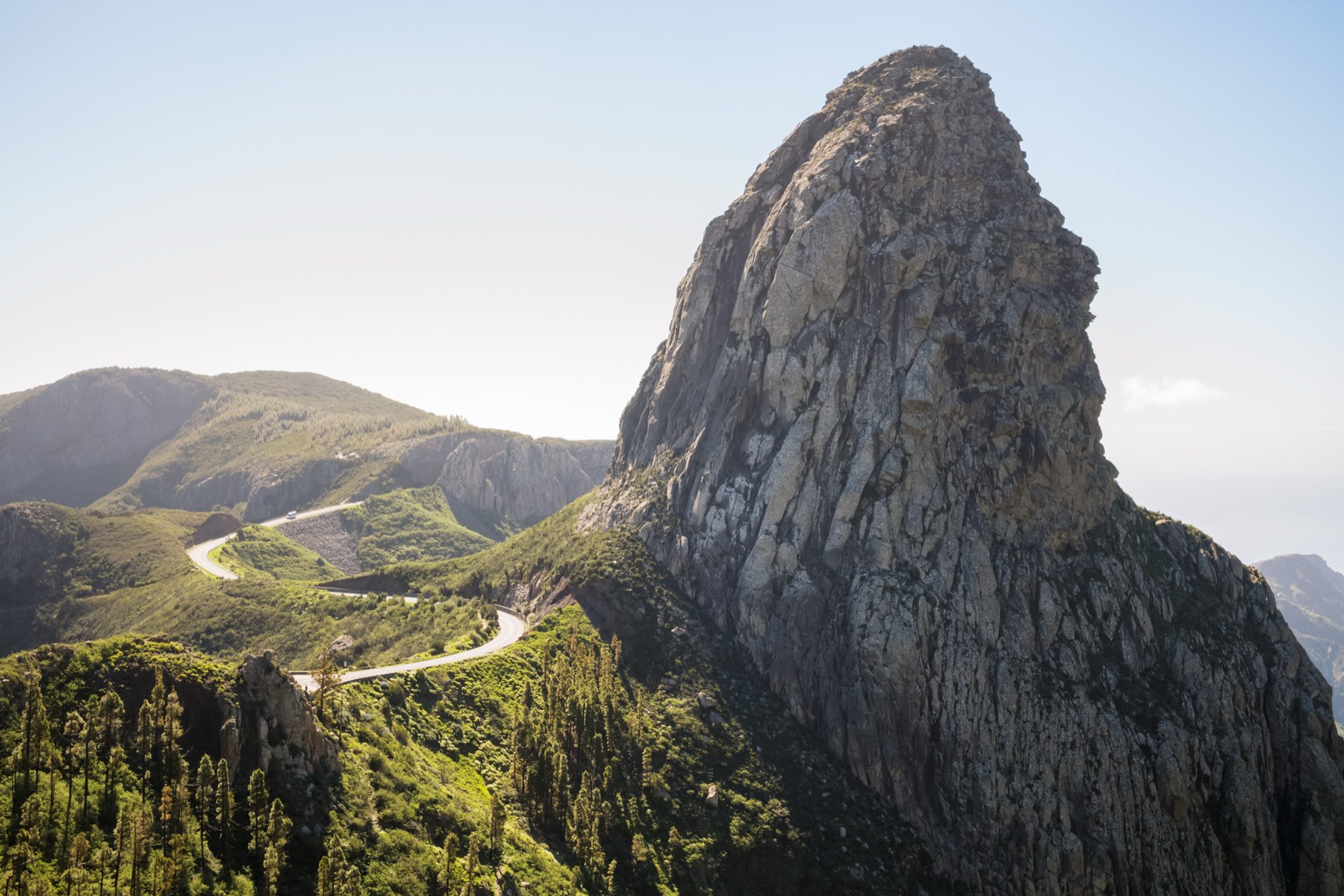 Volcanic rock spire above a winding mountain road